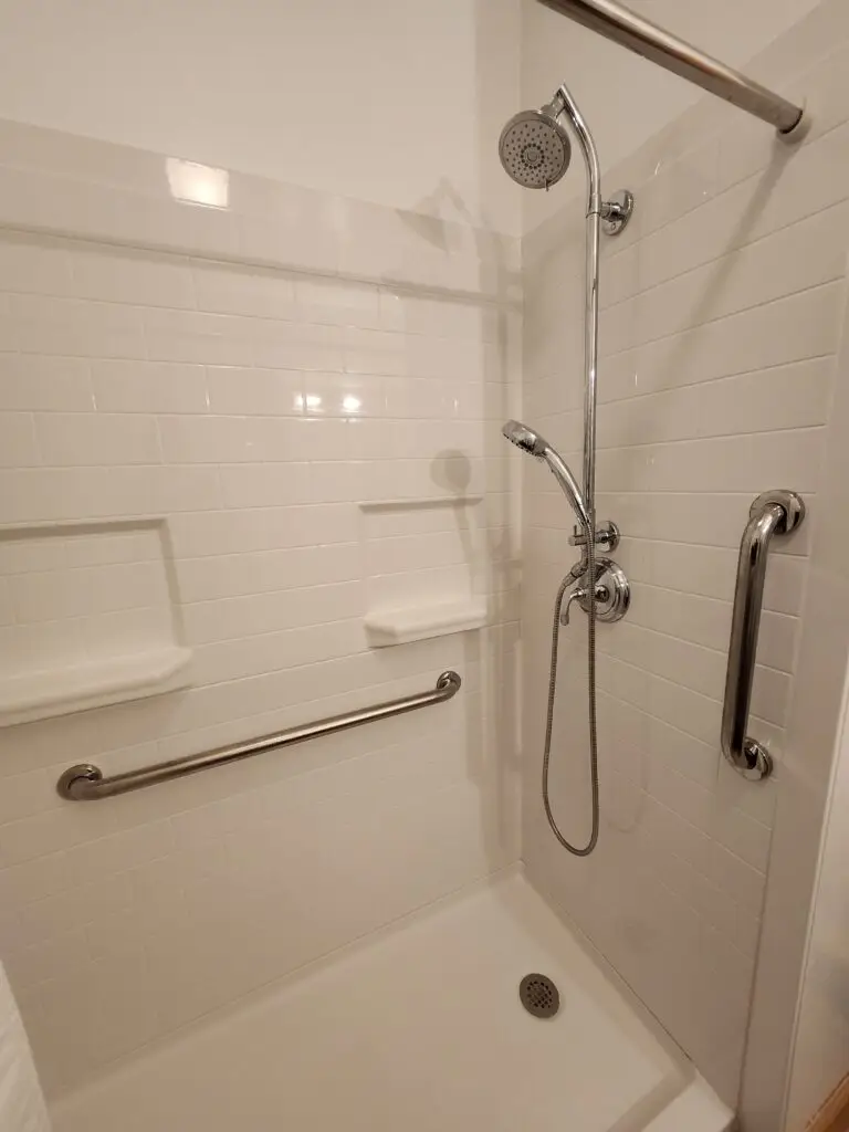 Photograph of a shower remodel with grab bars and hydro rail system completed by Adaptive Remodeling Solutions
