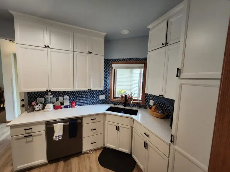 Photograph of a kitchen remodeling done by Adaptive Remodeling Solutions with white cabinets, kitchen counter, and sink.