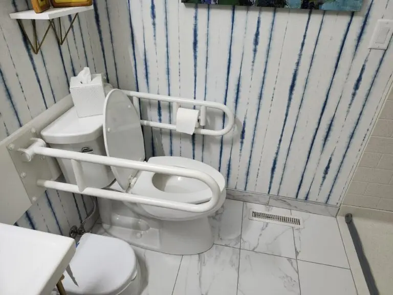 Photograph of a toilet with adjustable arm railings/ grab bar installed by Adaptive Remodeling Solutions.
