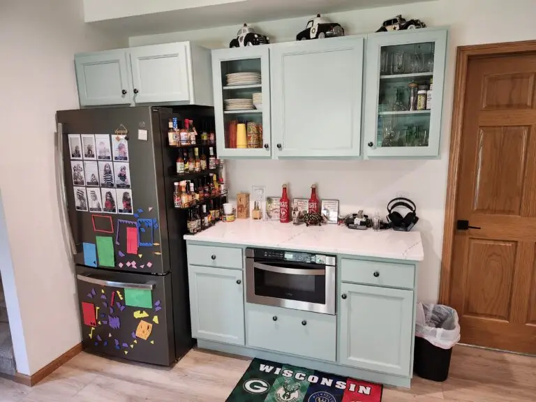 Photograph of a kitchen remodel by Adaptive Remodeling Solutions including a white cabinet installation, fridge, and wheelchair accessible oven.