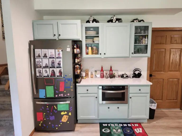 Photograph of a kitchen remodel by Adaptive Remodeling Solutions including a white cabinet installation, fridge, and wheelchair accessible oven.