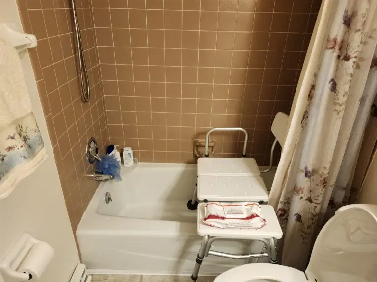Photograph of a shower seat inside a bathtub.