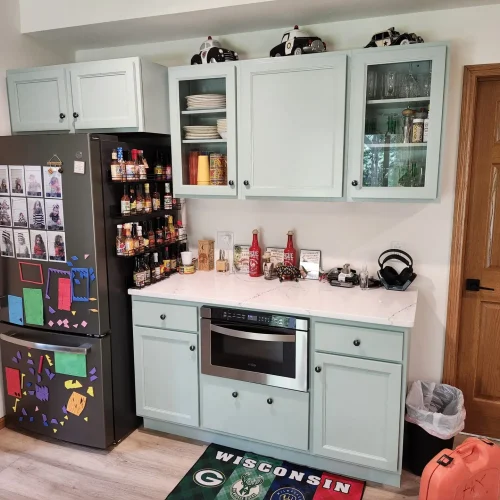 Photograph of a kitchen remodel by Adaptive Remodeling Solutions including a white cabinet installation, fridge, and wheelchair accessible oven.