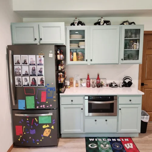Photograph of a kitchen remodel by Adaptive Remodeling Solutions including a white cabinet installation, fridge, and wheelchair accessible oven.