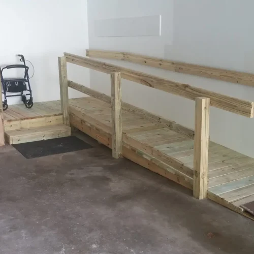 Photograph of wooden wheelchair ramp inside a garage, installed by Adaptive Remodeling Solutions.